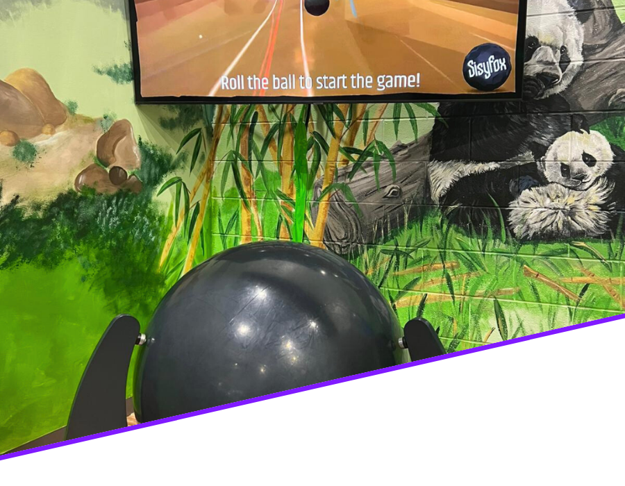 14 Bright and colorful coin-operated ride-on toys including a hot dog-themed car and cheerful cartoon characters, enhancing the fun experience at an indoor playground for children.